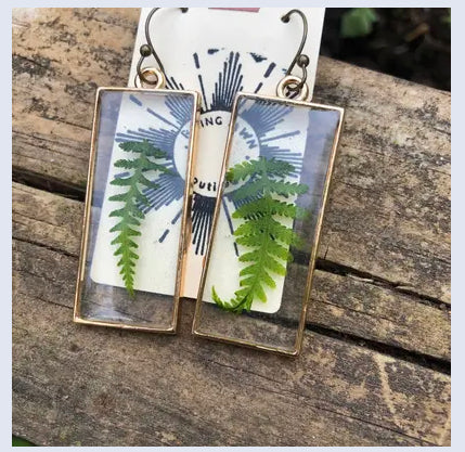 Resin earrings with dried ferns in a gold frame