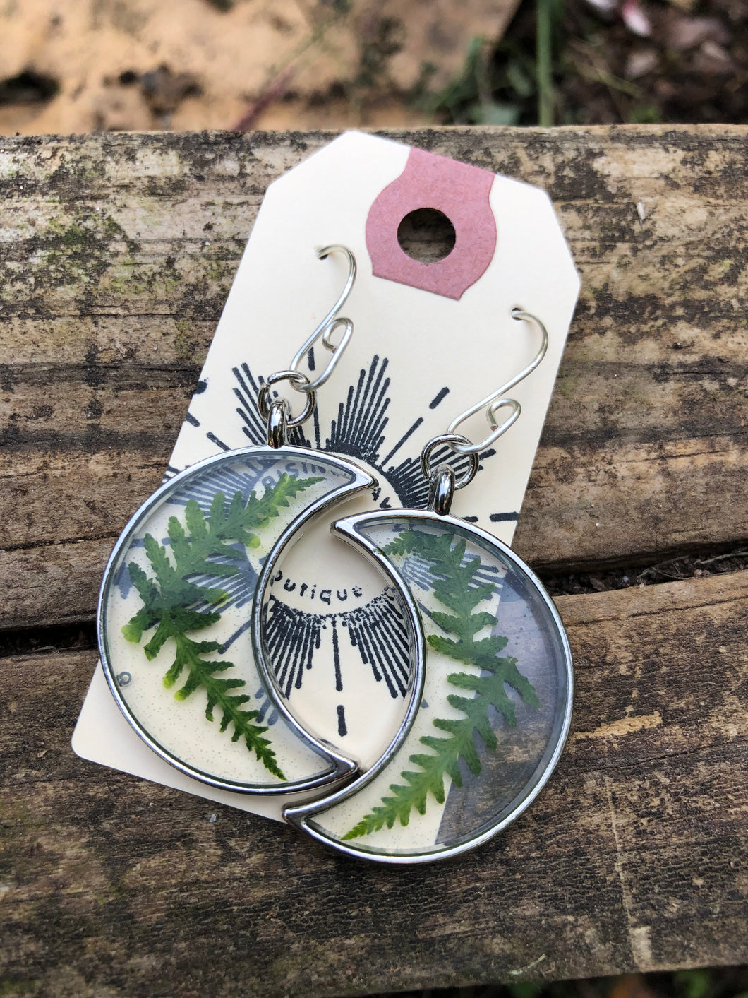 Resin earrings with dried ferns in a silver moon frame