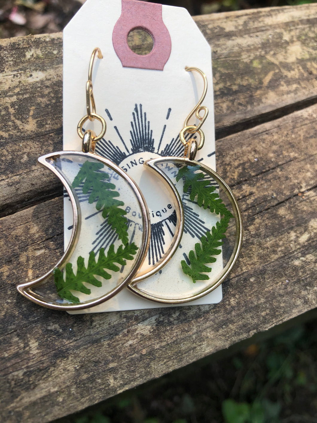 Resin earrings with dried ferns in a gold moon frame